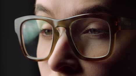 Macro-face-details-of-surprised-business-woman-watching-something-in-glasses.