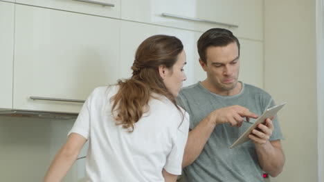 closeup couple choosing recipe for breakfast at home.