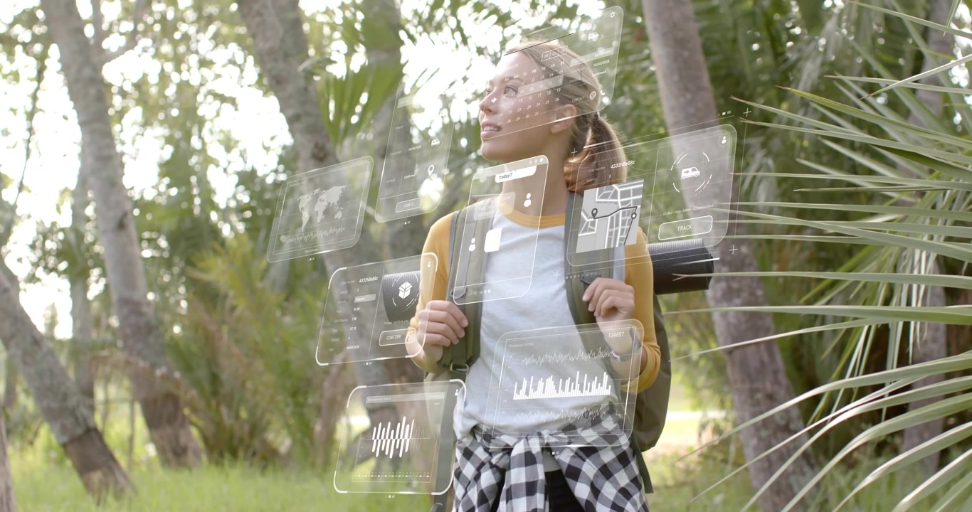 Female hiker stepping into sunlit grove and activating AR panels displaying trail map, fitness data