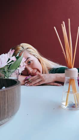 woman with flowers and diffuser