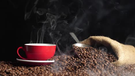 coffee cup and coffee beans in hemp sack with steam, slow motion