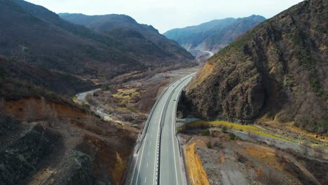 Cars-driving-fast-on-the-highway-that-runs-through-the-mountain-valley-in-the-north-of-Albania