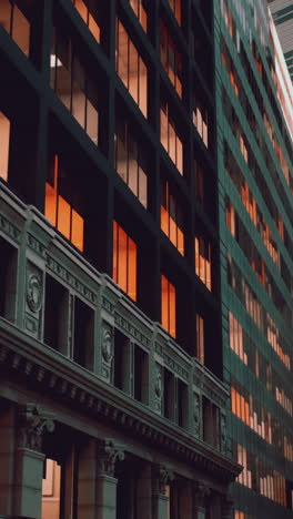 a tall building with many windows in a city at night