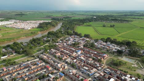 aerial view east of cali colombia, south america, cauca river, cane fields