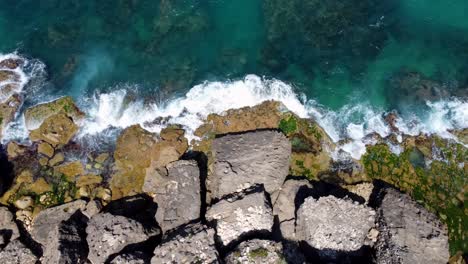 top view of ocean waves crashing at the rocky seashore in al fidar, lebanon