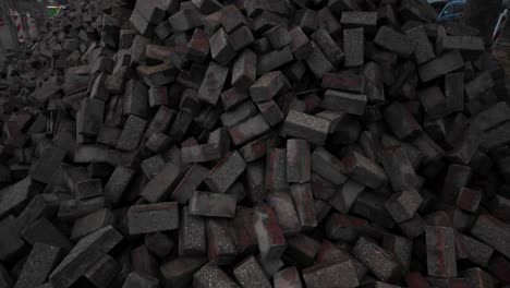 large pile of brickstones lie on the street in amsterdam neighborhood during road works