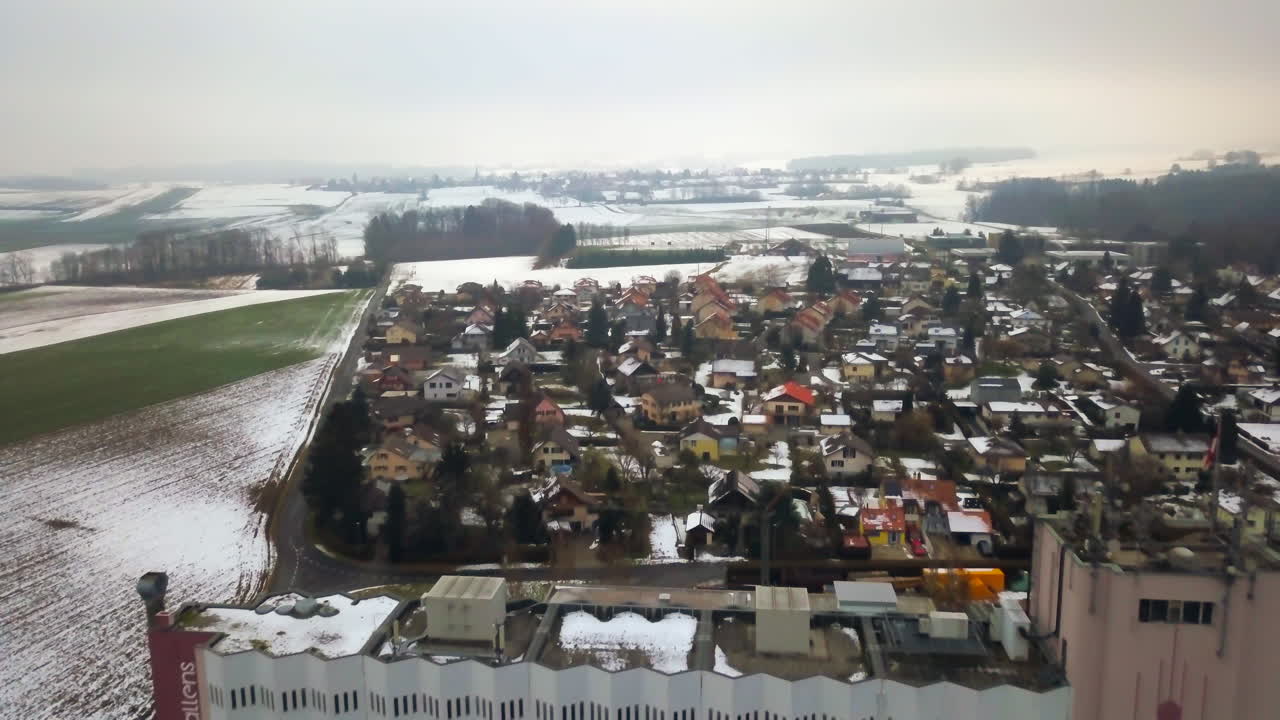 Echallens collecting center and cityscape at winter, Swiss. Aerial backward