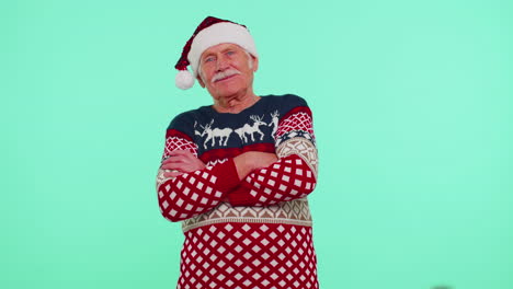 Elderly-senior-lovely-grandfather-man-wears-red-New-Year-sweater-and-hat-smiling,-looking-at-camera