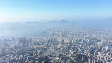 Hong-Kong-bay-and-skyline-with-skyscrapers,-high-altitude-wide-shot