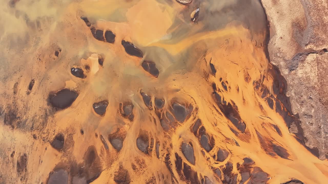Golden river flowing through the volcanic landscape of Þjórsá in Iceland