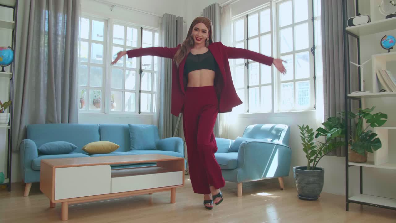 Young Fashion Transgender Woman Wearing Red Clothes Walking And Posing In Home