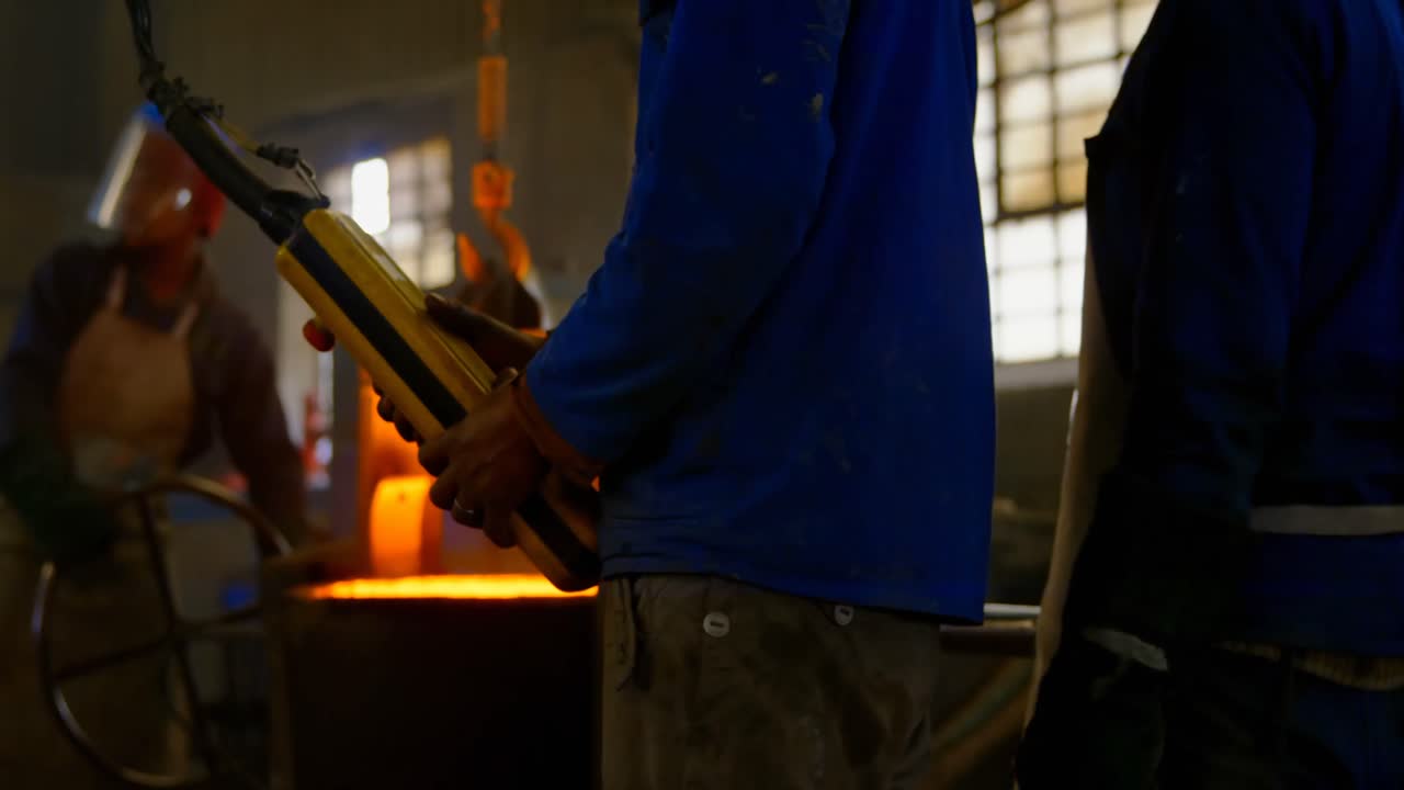 Male worker operating overhead crane machine in workshop 4k