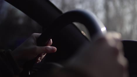 hands of a man driving a car in 4k