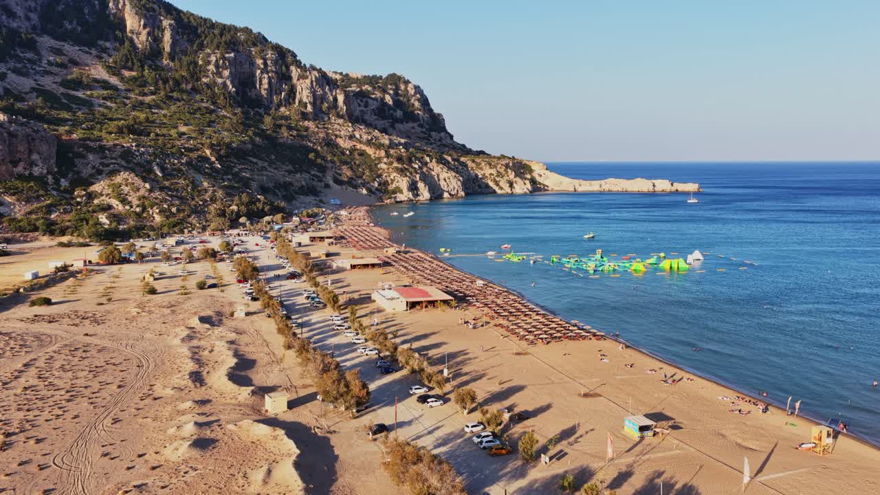 Aerial view of a beach with mountains and clear blue sea