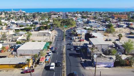 View-of-a-drone-flying-closer-to-a-roundabout-in-a-town-close-to-the-coast