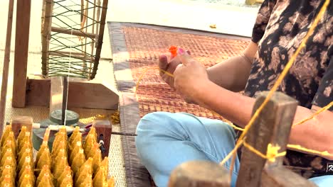 hands weaving silk in khao yai, thailand