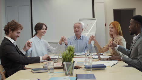 cheerful coworkers celebrating successful deal