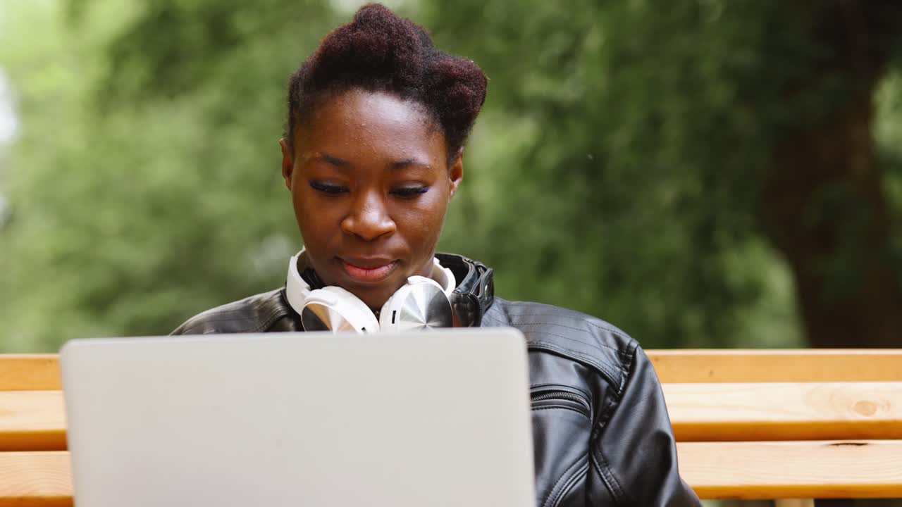 Woman Working on Laptop in Park