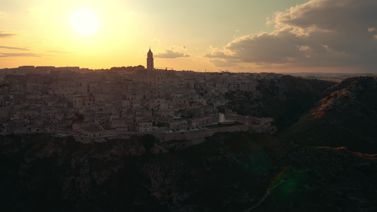 Time lapse of historic Matera Sassi seen from golden fields in warm late afternoon sunlight. Italy