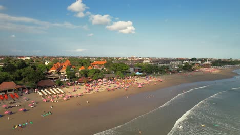 Crowded-with-People-at-Double-Six-Beach-in-Seminyak-Bali-Indonesia---Aerial-Parallax-Revealing-on-Sunny-Summer-Day