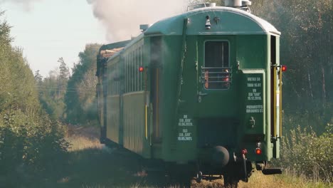 the old train travels on the railway tracks