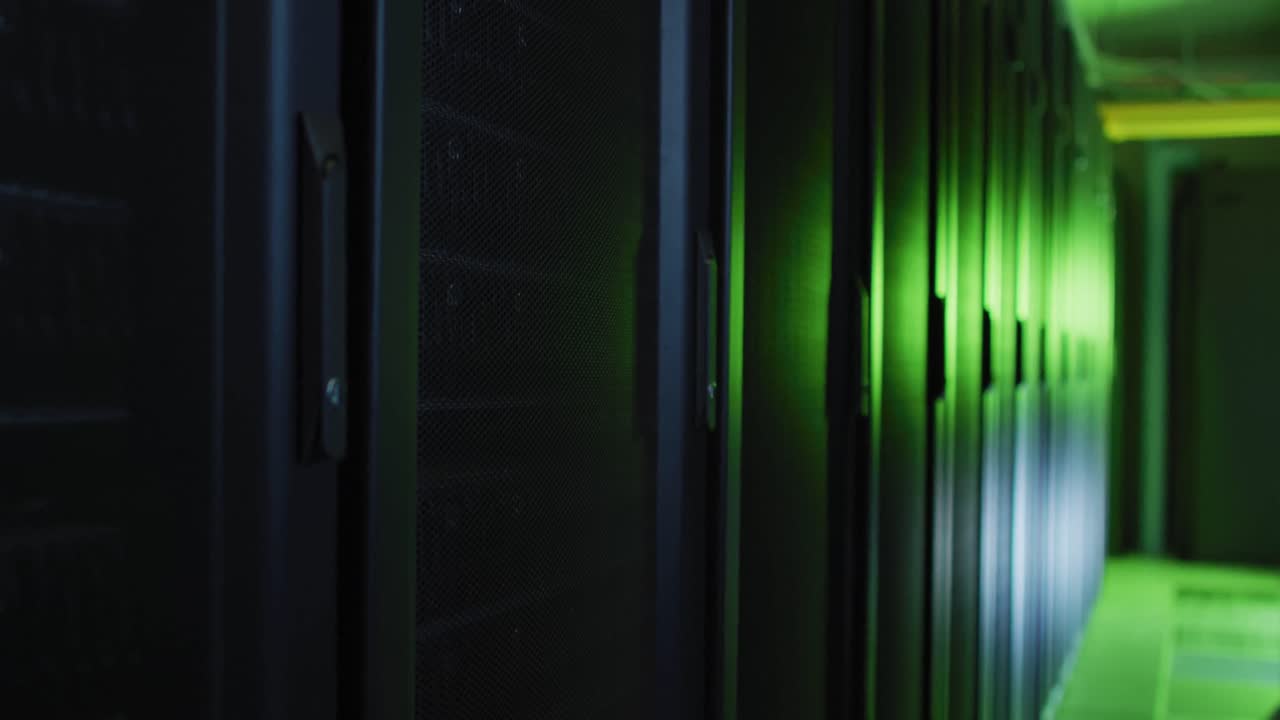 Green control lights reflected on computer servers in tech room