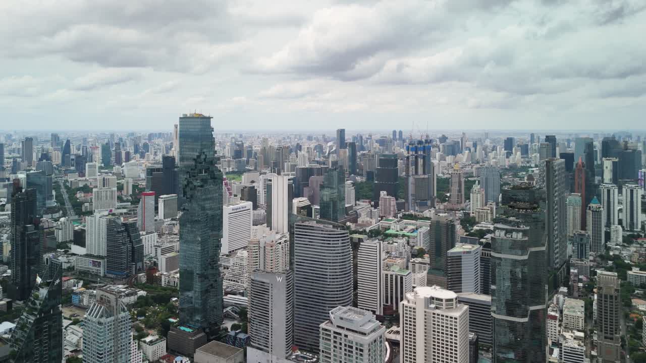 Modern office building with transport road downtown Silom Sathorn city Bangkok Thailand aerial view
