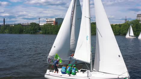 sailboats on a river with industrial background