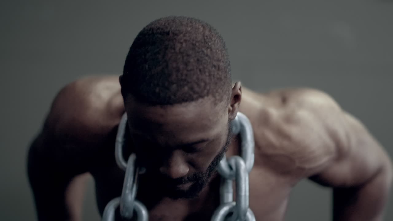 Athletic african american man doing weighted dips