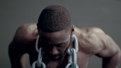 athletic african american man doing weighted dips