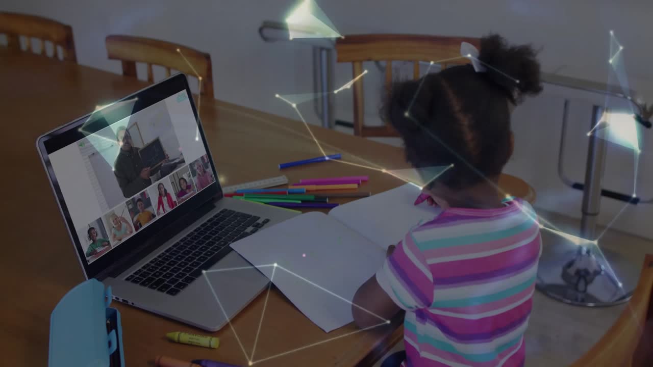 Elementary school girl writing in virtual classroom creating network shapes into rotating globe