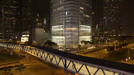 hong kong cityscape at night with pedestrian bridge