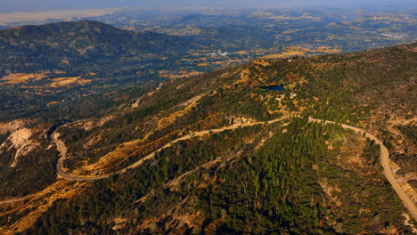 Aerial View of Mountainous Landscape with Winding Road and Lake