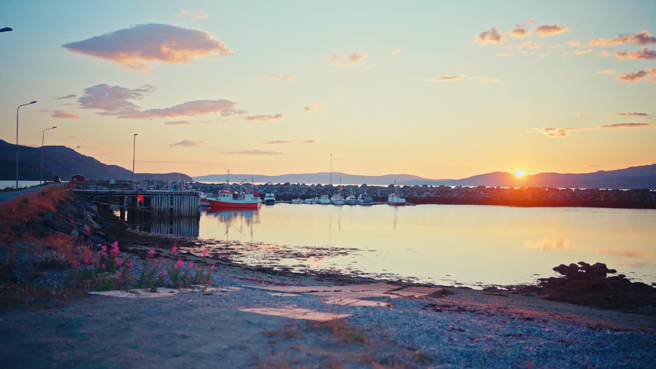 Kokelv, Hammerfest, Finnmark, Norway - Boats Docked For the Night as the Sun Sets, With Fireweed Adding a Pop of Color to the Shore - Wide Shot