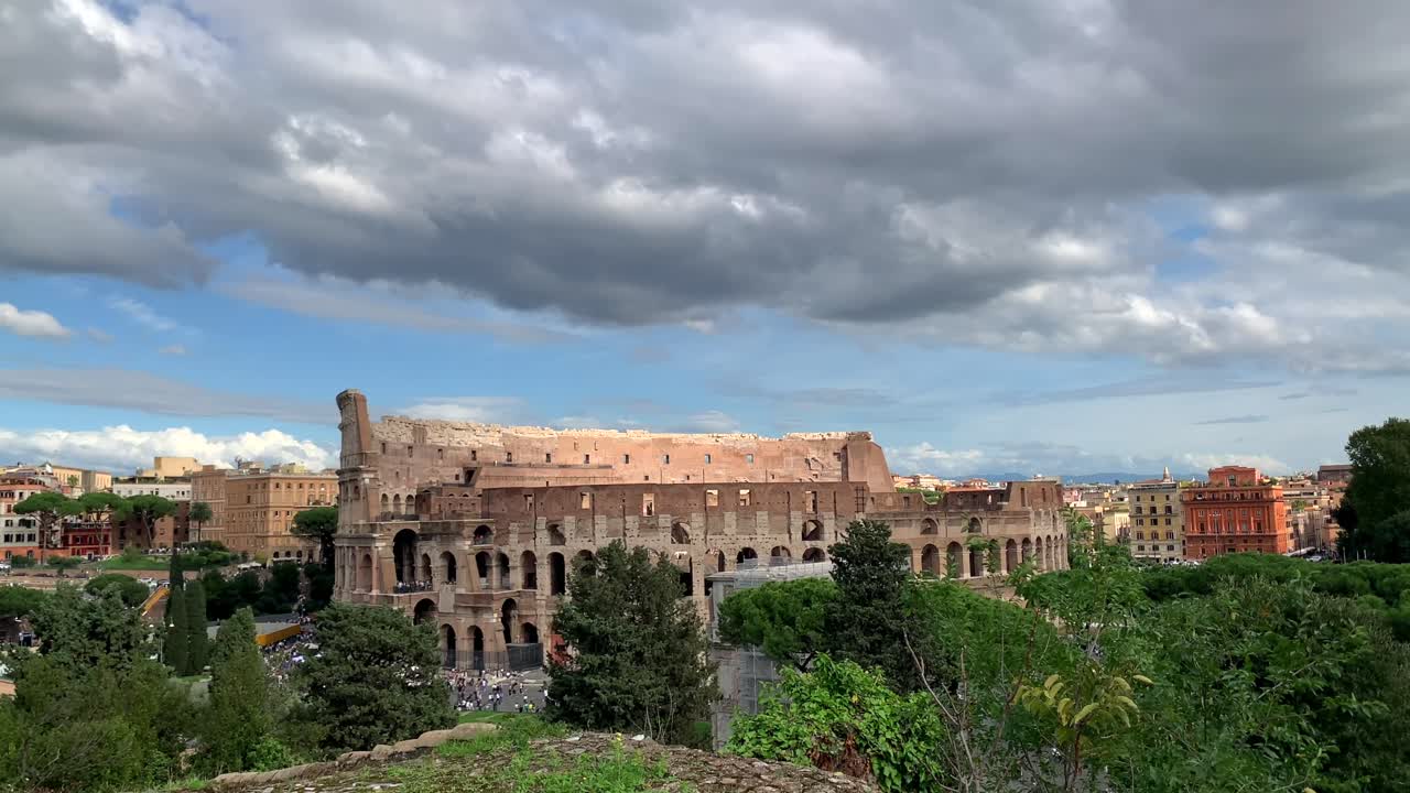 Wide view of Colosseum, Rome, Italy under blue skies