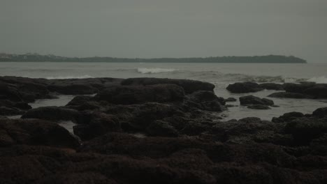 cinematic shot of a volcanic tropical beach on the indian coastline during the rainy season