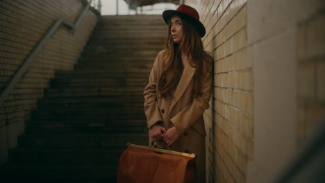 Thoughtful-Woman-Leaning-Against-Wall