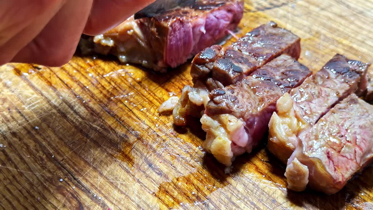 Primo piano di una bistecca alla griglia deliziosa e succosa tagliata su un tagliere di legno.
