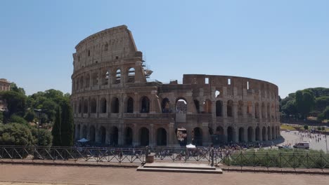 crowds of tourists outside the colosseum in rome on a sunny day