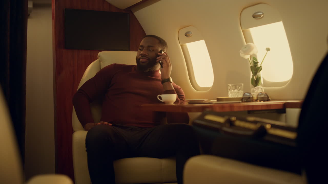 Plane passenger talking cellphone on vacation trip. Confident businessman work