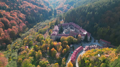 aerial view of the rila monastery surrounded by colorful autumn foliage in the rila mountains, bulgaria