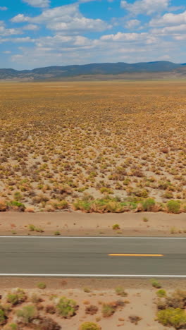 desert highway car driving. nevada desert road aerial shot. vertical video