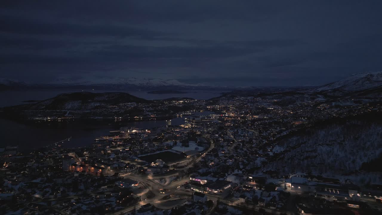 Aerial View of a Snowy City at Night