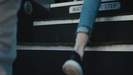 diverse children legs boarding schoolbus closeup. pupils going upstairs vehicle