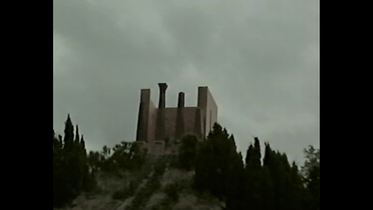 Building on a hill under cloudy sky