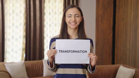 Happy-Indian-woman-holding-TRANSFORMATION-banner