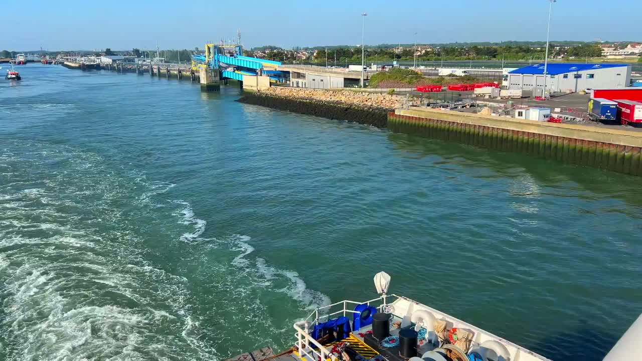 Ferry leaving Portsmouth harbour on a calm sea and wake.