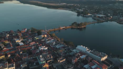 aerial view of a town by a lake at sunset