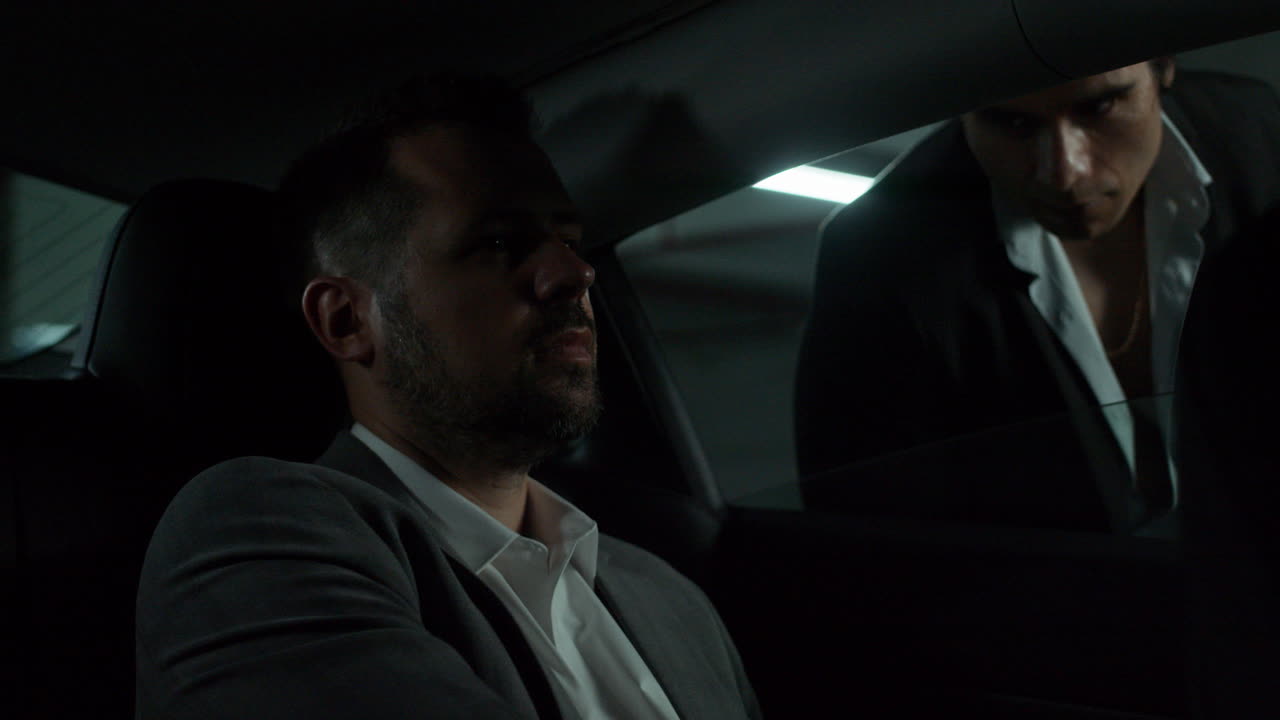 Business Meeting in a Parking Garage at Night