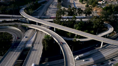 aerial view of a busy highway interchange with freeways and trains